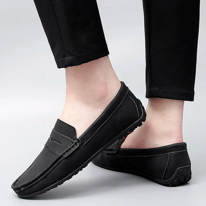 Men's casual brown leather penny loafers, an ideal footwear for relaxed settings.