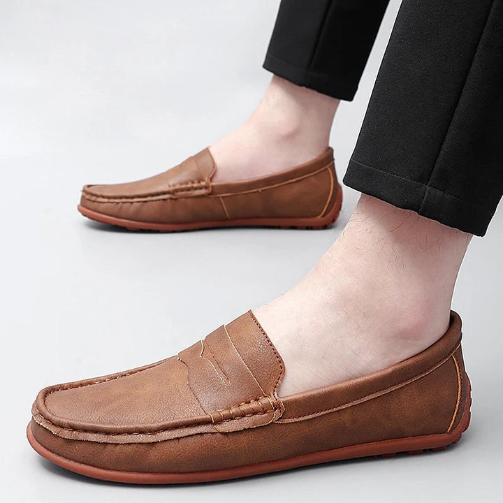 Classic men's leather penny loafers with a polished finish, enhancing any outfit.