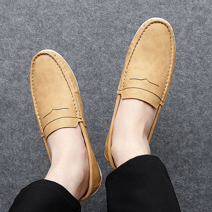 Side profile of a men's elegant leather penny loafer, highlighting its sleek design.