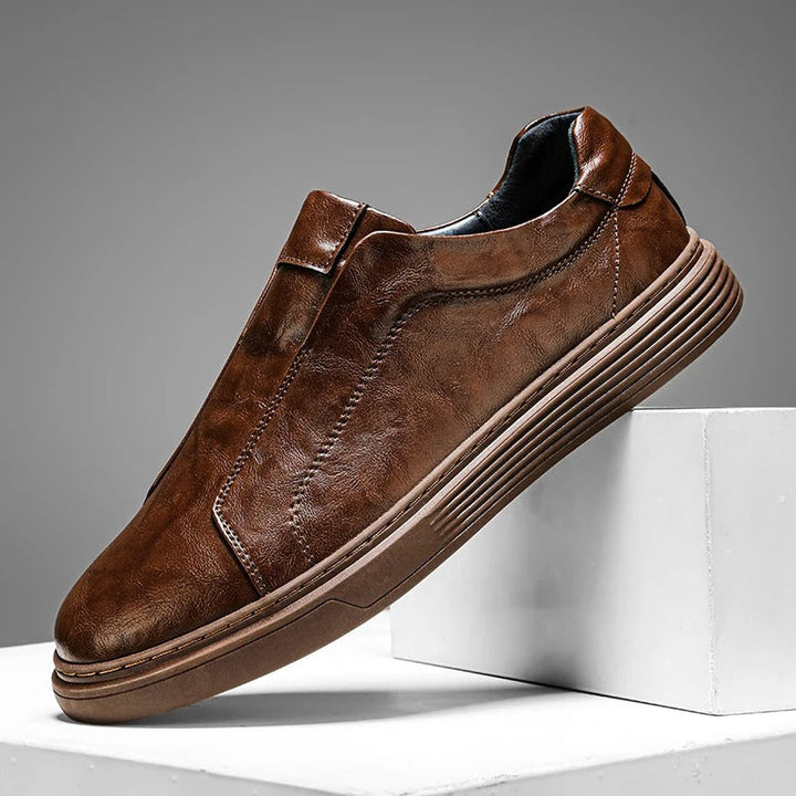 Black leather slip-on casual shoes for men, stylish and comfortable sneakers for daily use.
