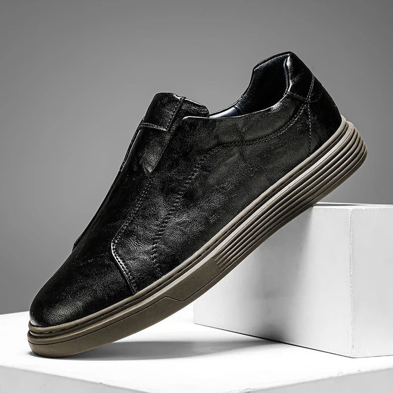 Side view of black men's slip-on leather shoes, showcasing their sleek design and casual comfort.