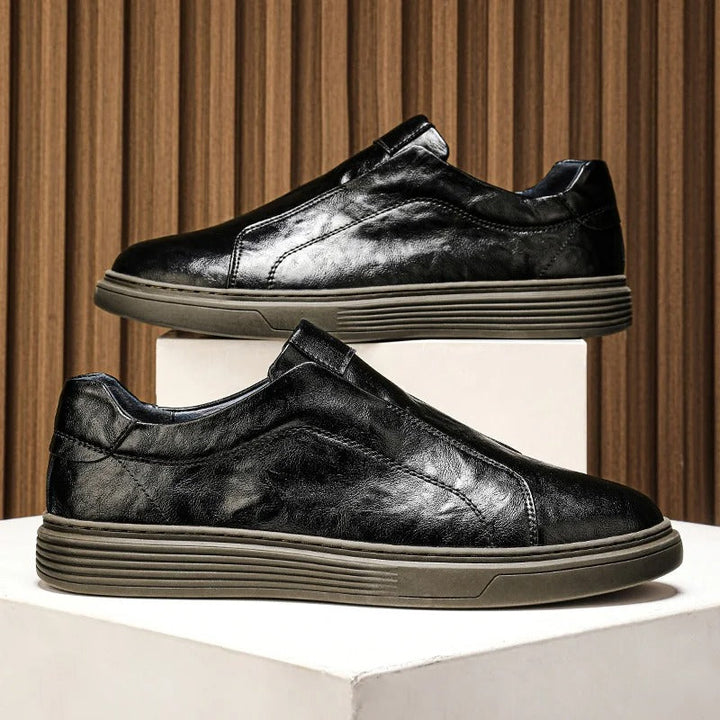 Top-down view of white leather slip-on sneakers for men, ideal for easy, comfortable everyday wear.