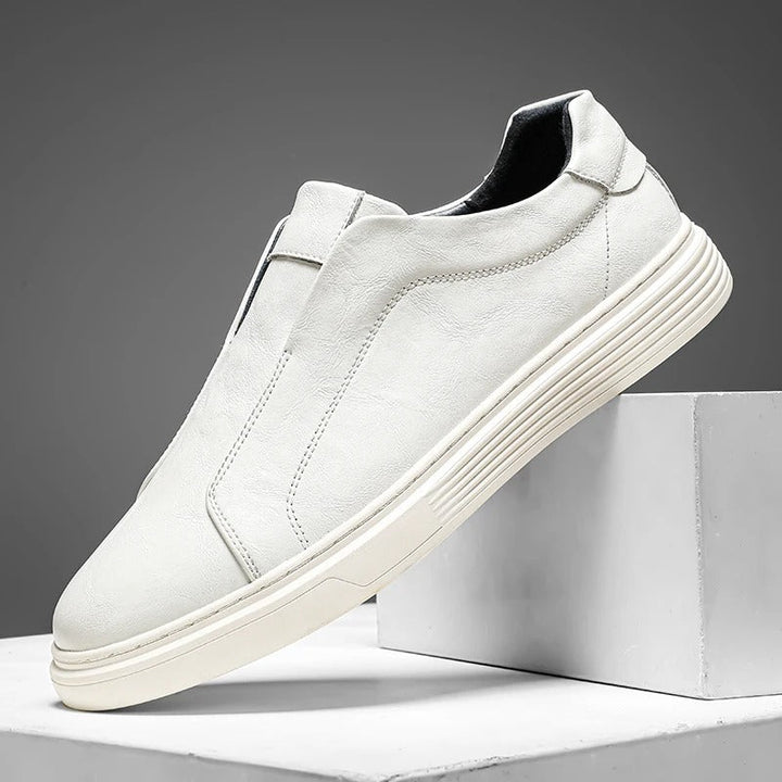 Men's brown leather slip-on casual shoes paired with jeans, demonstrating comfortable and stylish footwear.