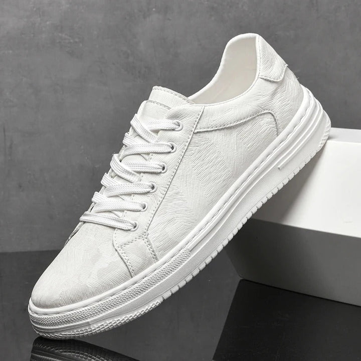Close-up of men's premium leather sneakers, showcasing texture and quality craftsmanship.