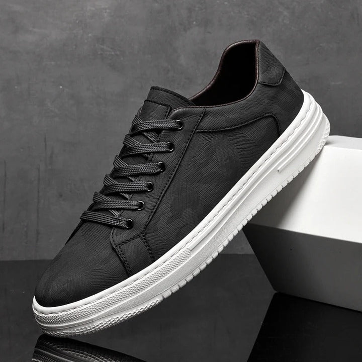 Detail of men's leather sneaker laces, indicating secure fit and classic footwear style.