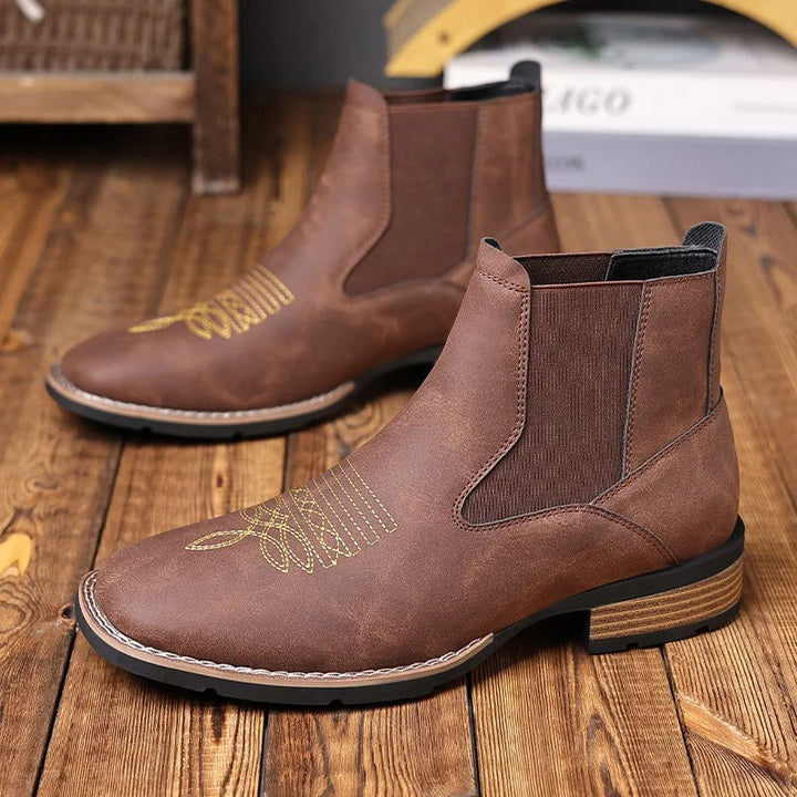 Detail shot of the stitching and stacked heel on a men's black Western Chelsea ankle boot