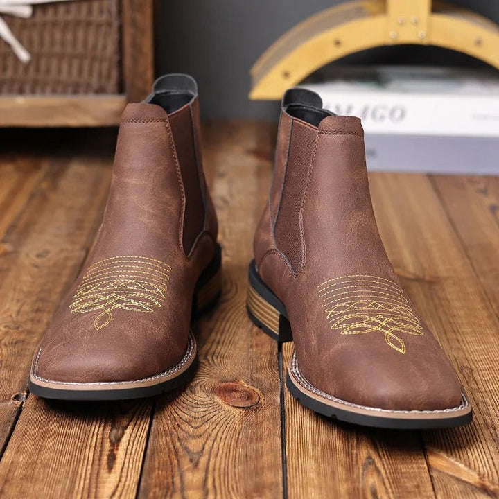 Full-body image of a man wearing brown Western Chelsea boots, styled casually
