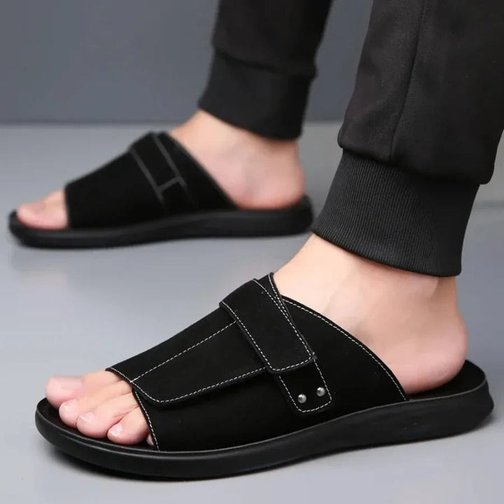 Stylish men's suede comfort slides with an adjustable strap, top view showcasing texture.