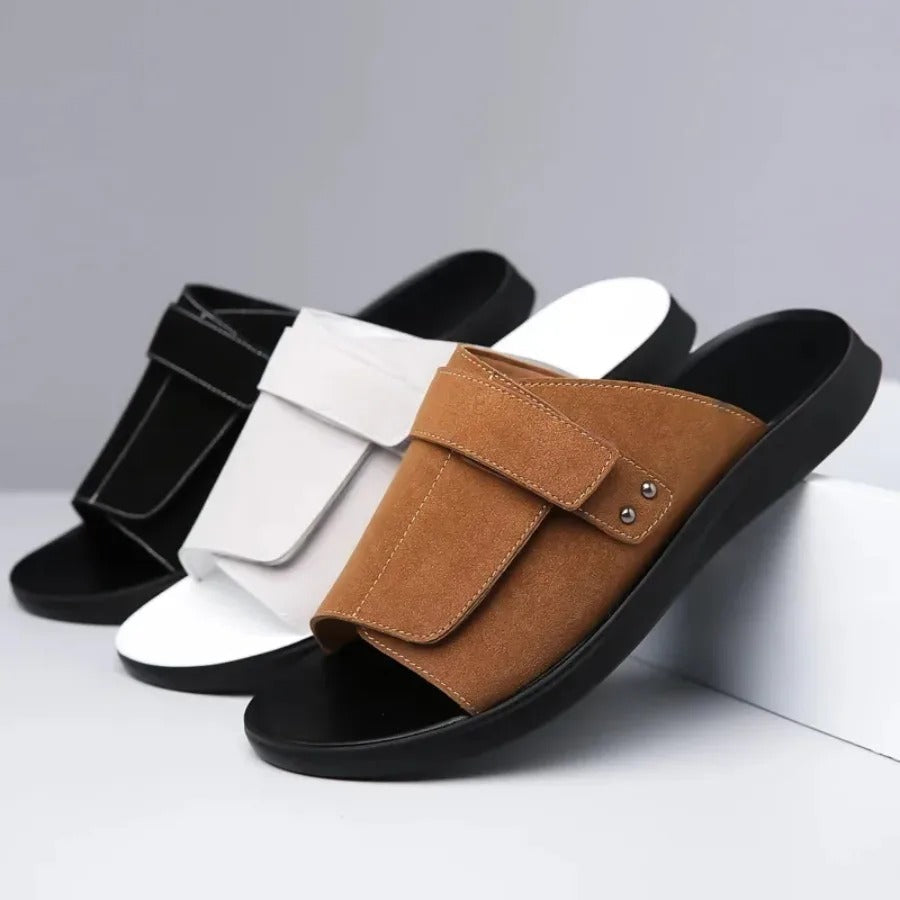 Side profile of men's brown suede slides, emphasizing the ergonomic design and comfort features.