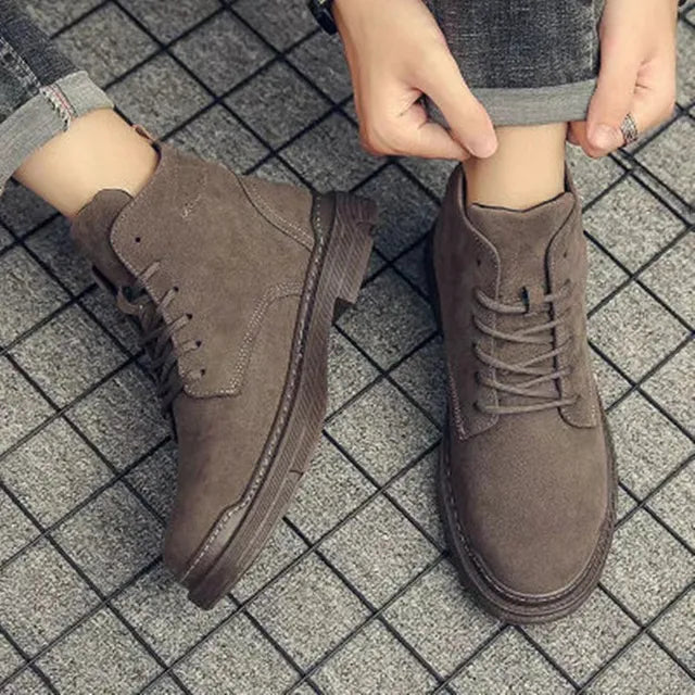 Pair of men's classic suede boots with laces, a versatile addition to any men's fashion collection