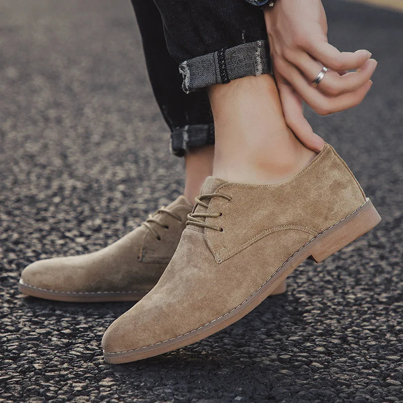 Men's fashion footwear: light brown suede Oxford shoes with traditional lace-up closure.