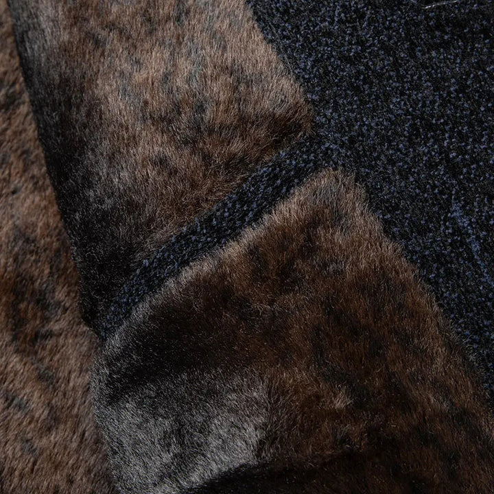 Close-up of the textured wool blend and soft fur lining of a men's classic button-up jacket.