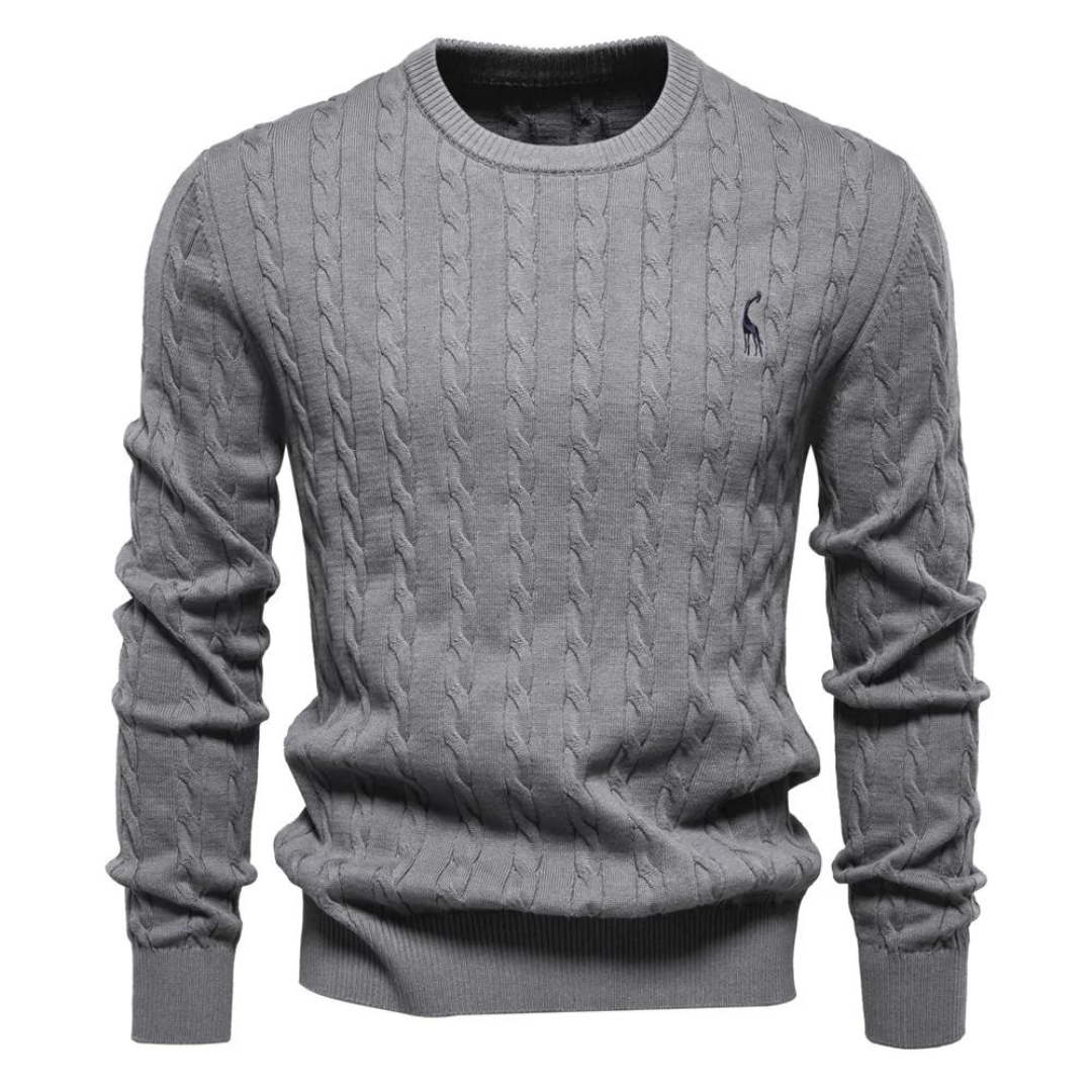 Close-up of a men's cream cable knit sweater, showcasing the intricate knit pattern and crew neck detail.