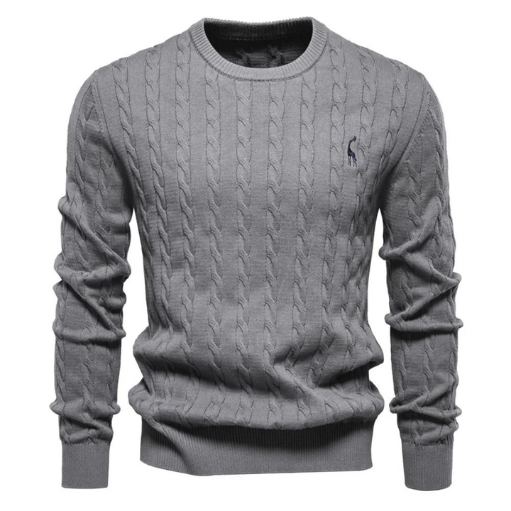 Close-up of a men's cream cable knit sweater, showcasing the intricate knit pattern and crew neck detail.