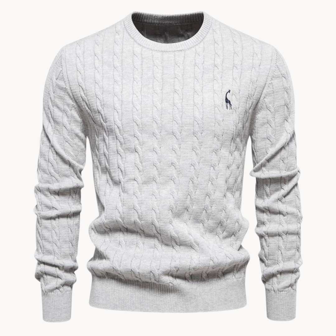 Folded men's classic white cable knit sweater, a quintessential piece of warm and stylish knitwear.