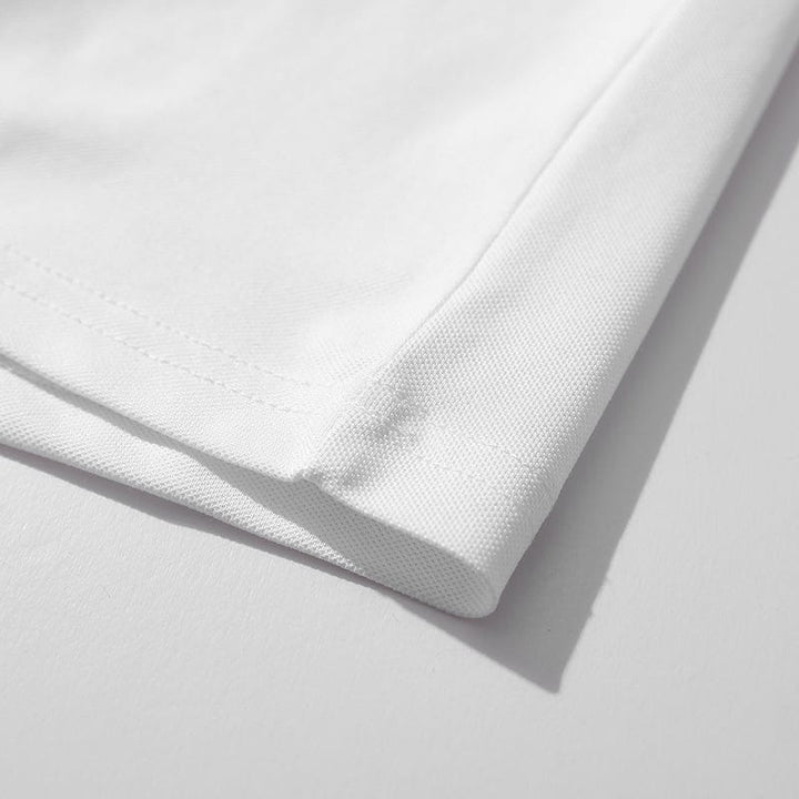 Stack of men's casual polo shirts in various colors, showcasing classic comfort