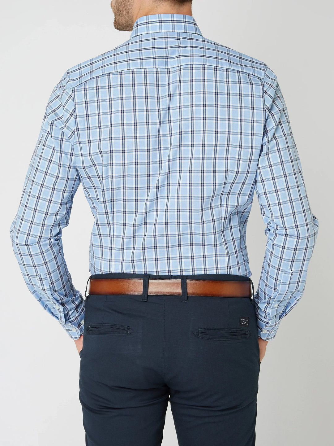 Detail shot of the buttons and collar on the men's classic checkered casual shirt