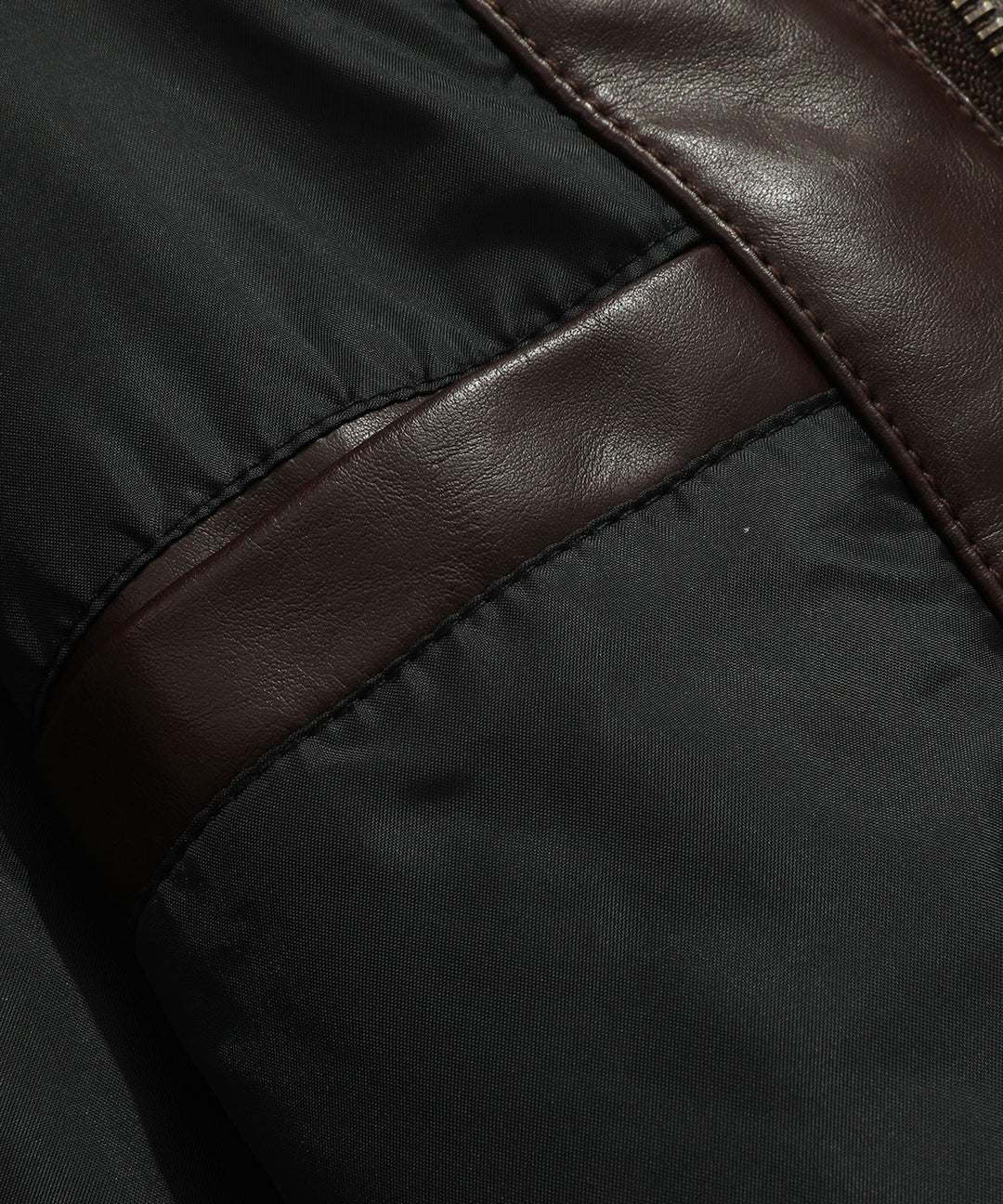 Model looking over shoulder, wearing a classic coffee faux leather jacket