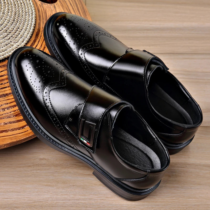 Men's classic leather dress shoes pictured with business suit trousers, formal gentleman look