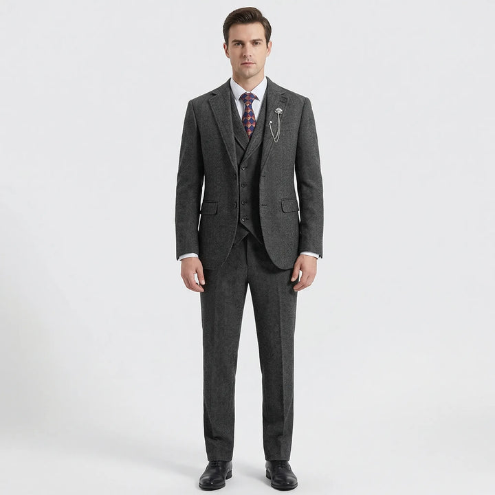 Close-up of elegant men's gray herringbone fabric on a 3-piece suit, showcasing the classic weave & quality.