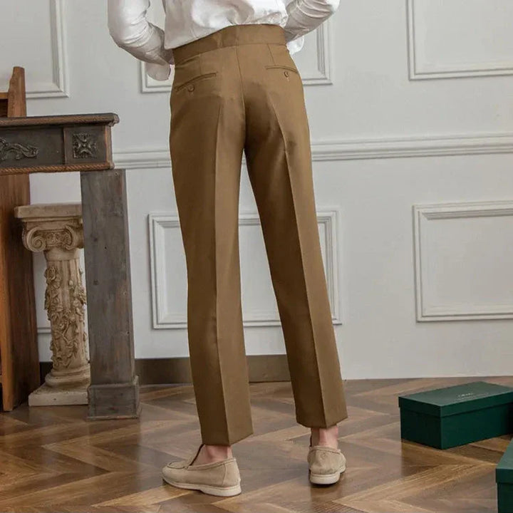 Close-up of the button and zipper closure on men's tailored straight leg dress pants, secure & sleek