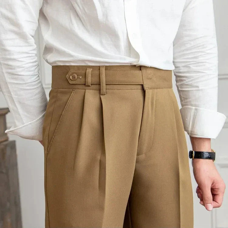 Stack of folded men's straight leg dress pants in various colors: black, navy, charcoal, light grey