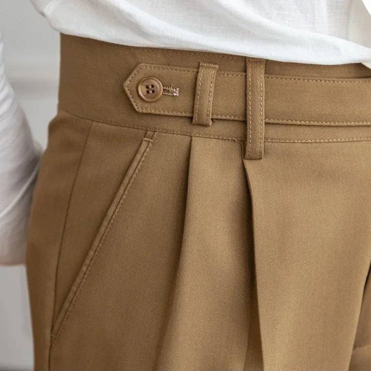 Men's straight leg dress pants laid flat, showcasing the precise tailoring and straight cut