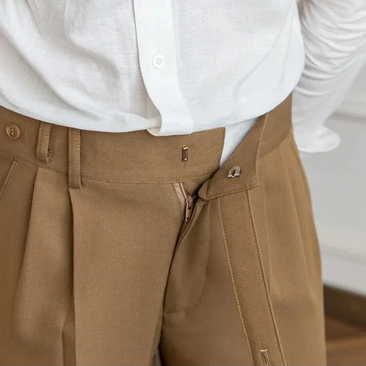 Men's high-rise straight leg dress pants paired with a belt and dress shoes for a complete outfit