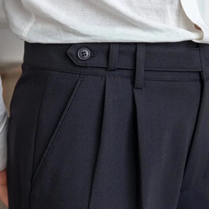 Men's straight leg dress pants, highlighting the crease down the front, a sign of classic tailoring
