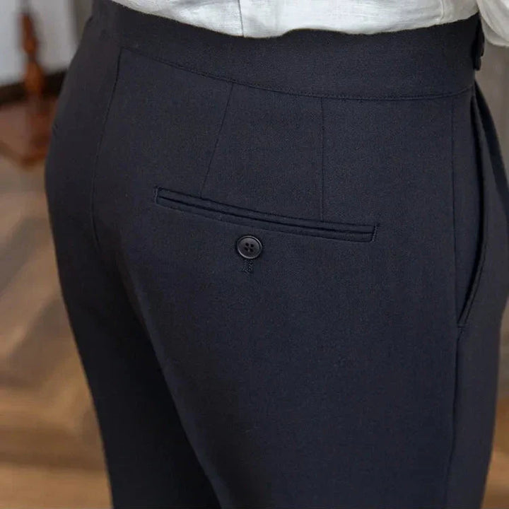 View of the back pockets on men's tailored straight leg dress pants, discreet and functional