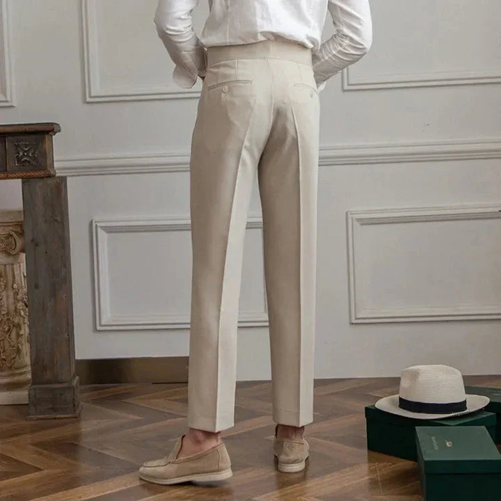 Men's straight leg dress pants in an indoor studio setting, vibrant lighting accentuating fabric