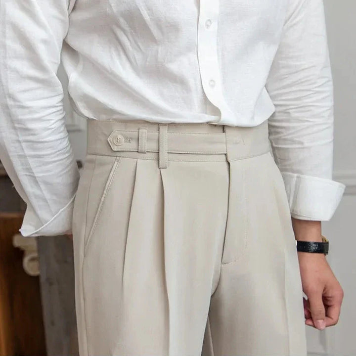 Model adjusting belt on men's comfortable straight leg dress pants, highlighting high-rise fit
