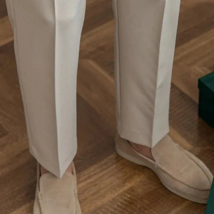 Dynamic pose of model wearing men's straight leg dress pants, emphasizing freedom of movement