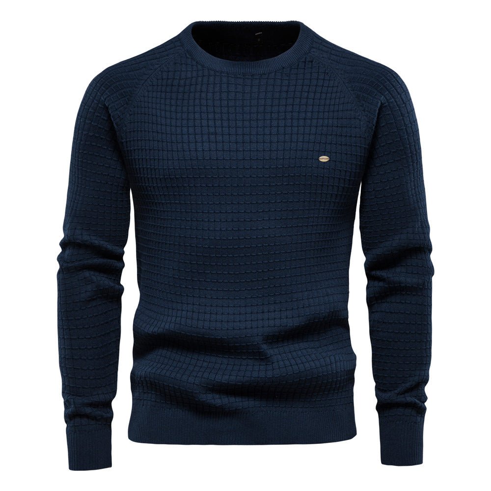 Close-up of the textured knit on a men's classic crewneck sweater, highlighting its quality.