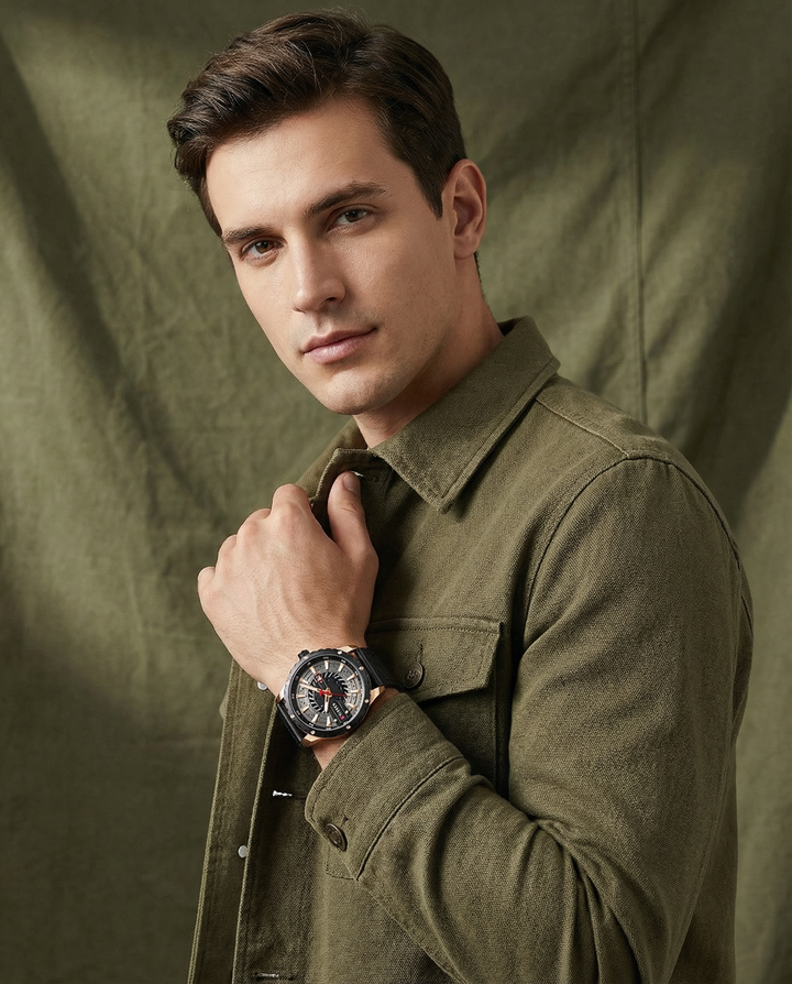 Close-up of a men's classic watch, showcasing a rich leather strap and detailed watch face.