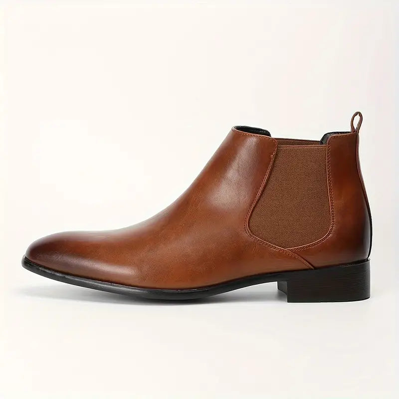 Bottom sole of men's black leather Chelsea boots, showcasing grip and quality construction