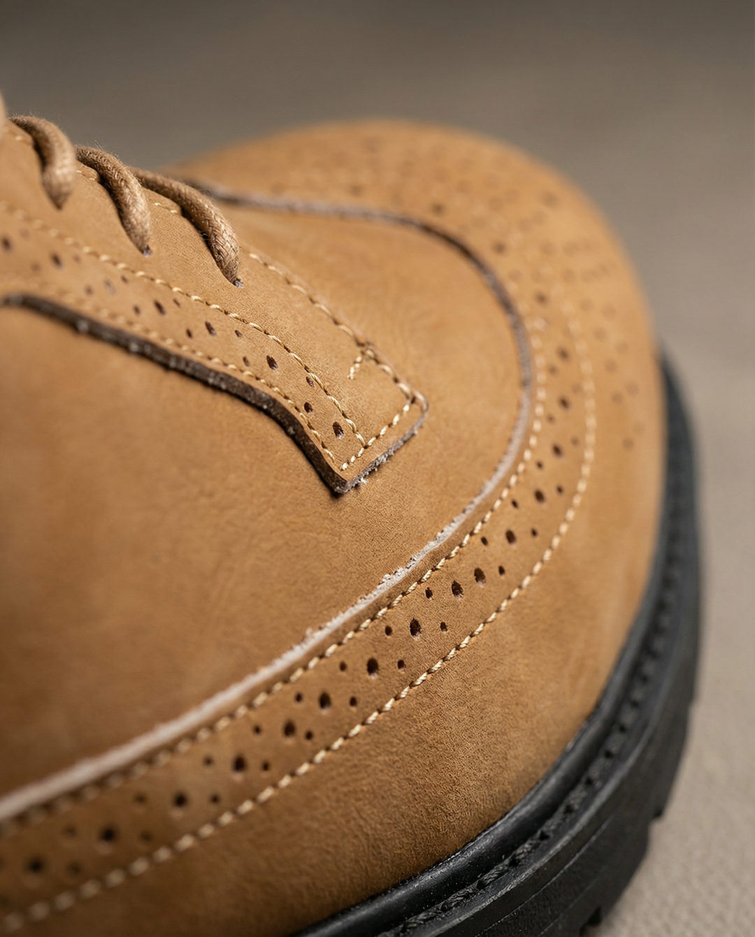 Close-up of the lug sole on men's leather derby shoes, highlighting traction & durability