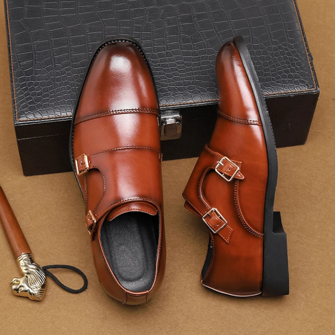 Close-up on the cap toe detail of men's leather double monk strap shoes, featuring a subtle, elegant seam