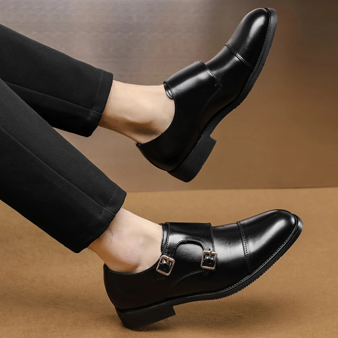 Side view of a men's classic leather double monk strap shoe highlighting the smooth leather and cap toe design