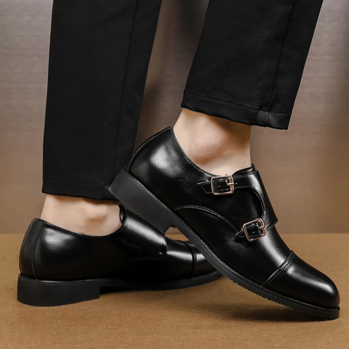 A pair of men's brown leather double monk strap dress shoes, ideal for a professional or gentleman's attire