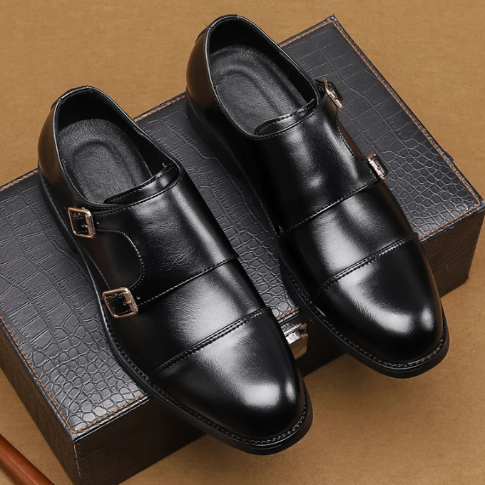 Detail of the double buckle on men's leather monk strap shoes, emphasizing the polished silver hardware