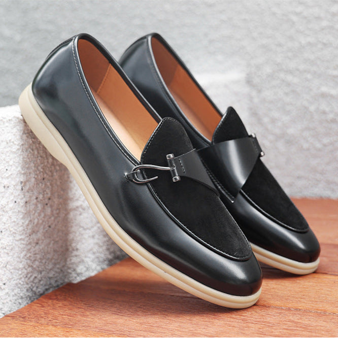 Close-up of men's black leather loafers featuring a sophisticated gold bit detail on the vamp