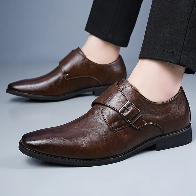Elegant men's black leather monk strap dress shoes with a polished buckle, ideal for business and formal occasions.