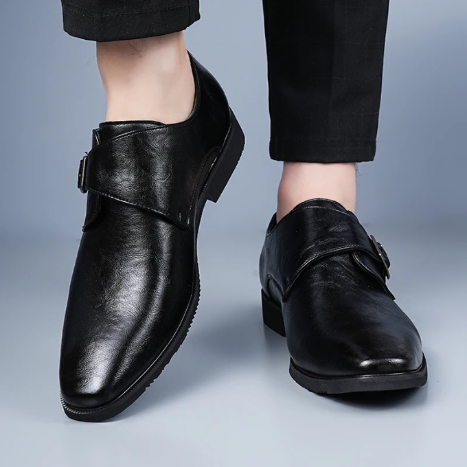 Side view of a men's classic leather monk strap shoe, revealing the sleek silhouette and quality leather. Gentleman's footwear.