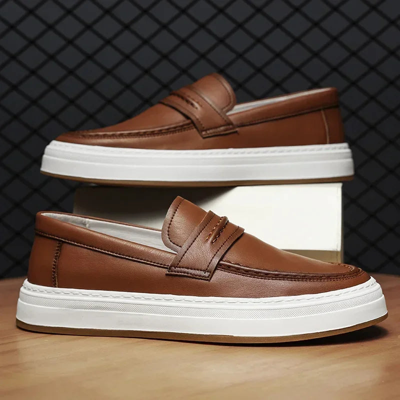 A pair of men's comfortable leather penny loafers with a modern chunky sole