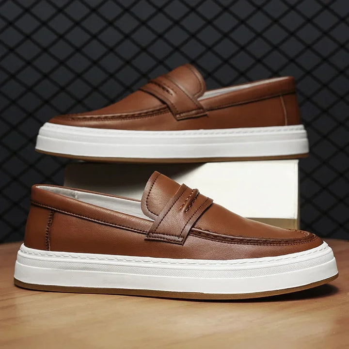 A pair of men's comfortable leather penny loafers with a modern chunky sole