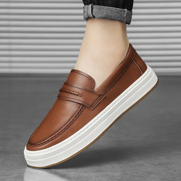 Side profile of men's stylish leather penny loafers, chunky sole for support