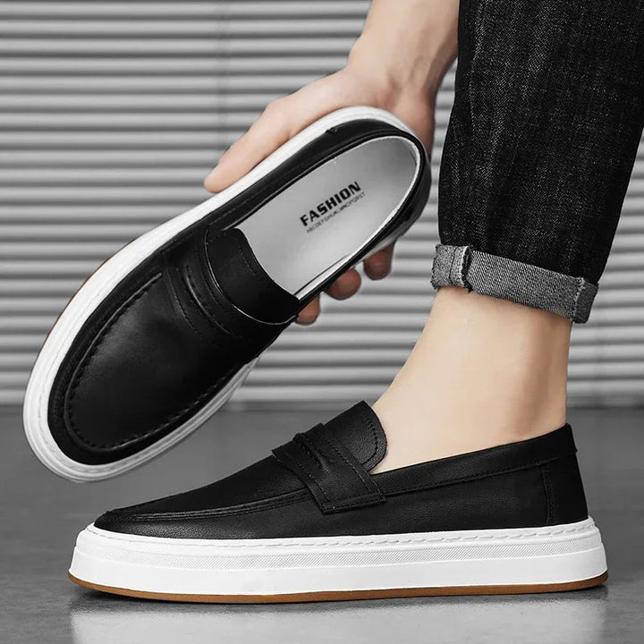 Close-up of men's black leather penny loafers with thick, chunky sole