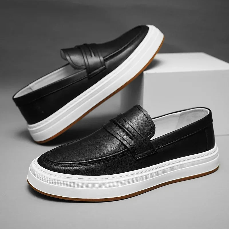 Front view of men's shiny black leather penny loafers, robust chunky sole