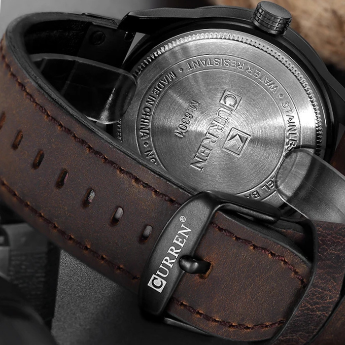 Wrist shot of men's leather strap watch, complementing a sophisticated outfit